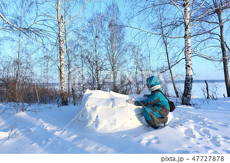 Happy woman building an igloo , Siberia, Russia 47727878