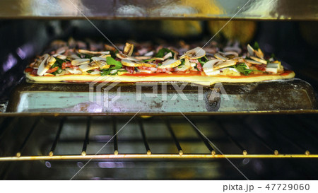 Pizza Making process. Pepperoni pizza in the oven Pizza Making process. Pepperoni pizza in the oven 47729060