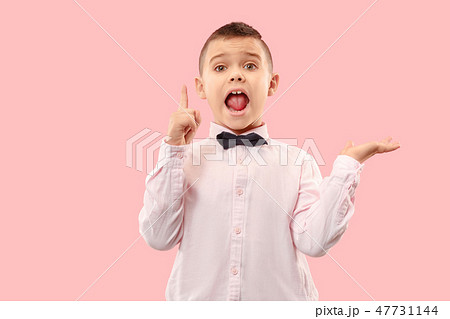 Isolated on pink young casual boy shouting at studio 47731144