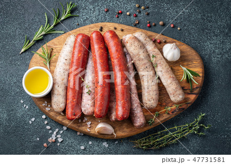 Assorted fresh sausages with thyme. Assorted fresh sausages with thyme. 47731581