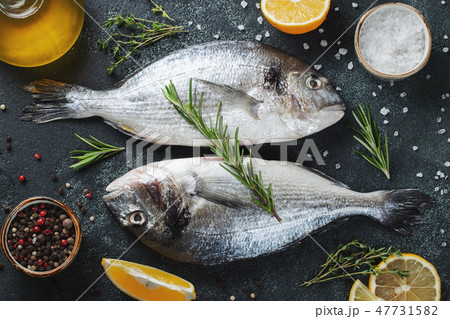 Two fresh raw Dorado fish with spices. 47731582