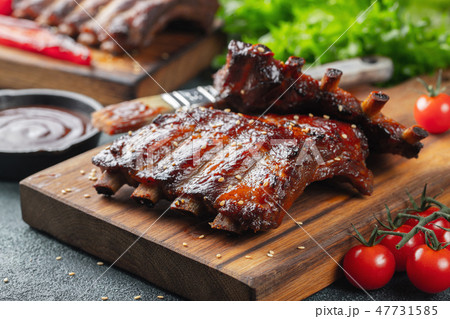 Closeup of pork ribs grilled with BBQ sauce. Closeup of pork ribs grilled with BBQ sauce. 47731585