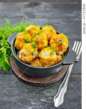 Meatballs in black brazier on board 47732806