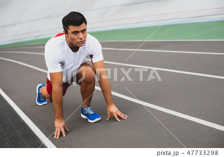 Focused young man is making workout outdoor 47733298