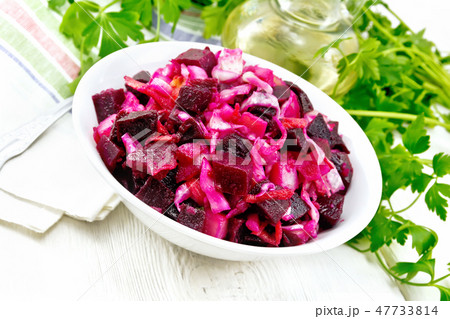 Vinaigrette with cabbage in bowl on board Vinaigrette with cabbage in bowl on board 47733814