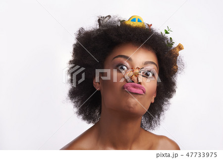 Ethnic lady grimace with bee on her nose Ethnic lady grimace with bee on her nose 47733975