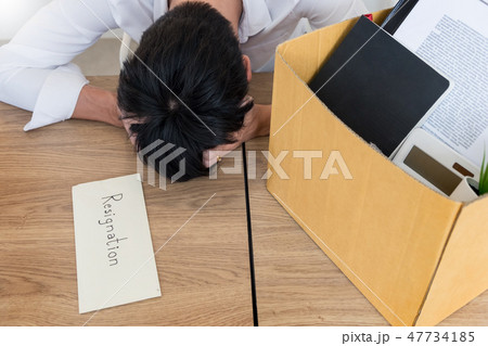 Businessmen are holding resignation document and packing persona 47734185