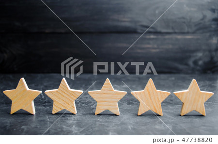 Five wooden stars. Get the fifth star.  47738820