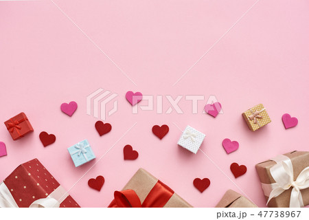 Big day for them. Cute gift boxes with decorative paper hearts on pink background Big day for them. Cute gift boxes with decorative paper hearts on pink background 47738967