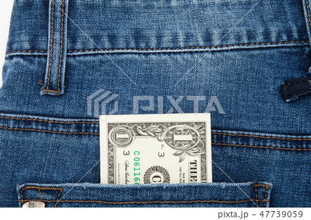 One dollar bill in the back pocket of blue jeans One dollar bill in the back pocket of blue jeans 47739059