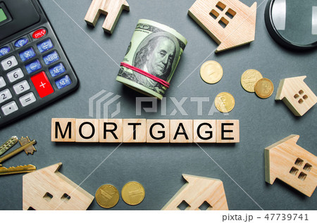 Wooden houses, a calculator, keys, coins  47739741