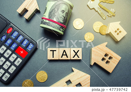 Wooden houses, a calculator, keys, coins  47739742