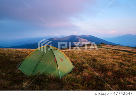 Green tent in spring mountains 47742647