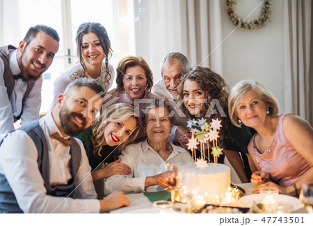 An elderly woman with multigeneration family celebrating birthday on indoor party. 47743501