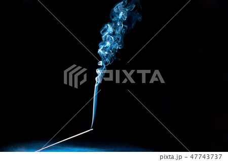 A mystic burning incense stick with scented smoke A mystic burning incense stick with scented smoke 47743737