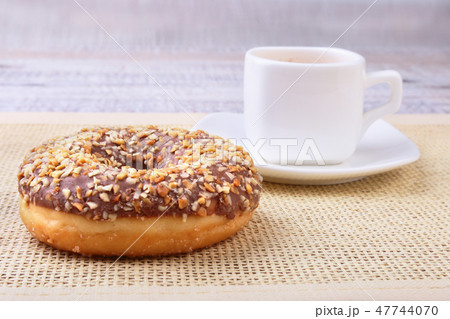 Coffee break with fresh donuts over textile background. 47744070