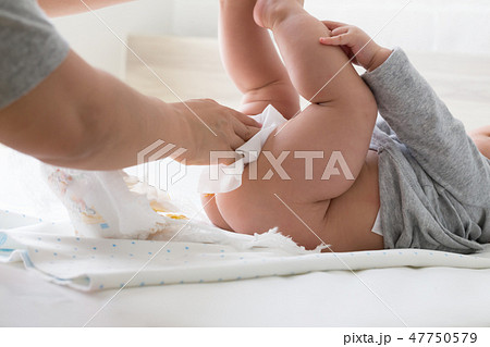 Diaper changing and cleaning bottom of baby Diaper changing and cleaning bottom of baby 47750579
