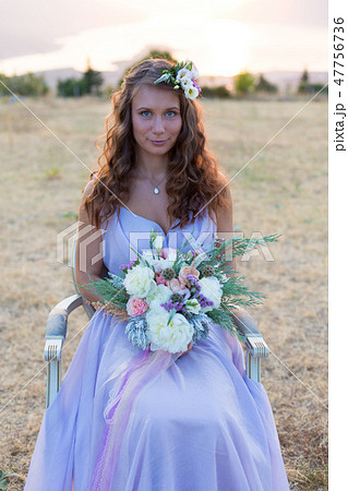 Attractive bride is holding a magnificent wedding bouquet Attractive bride is holding a magnificent wedding bouquet 47756736