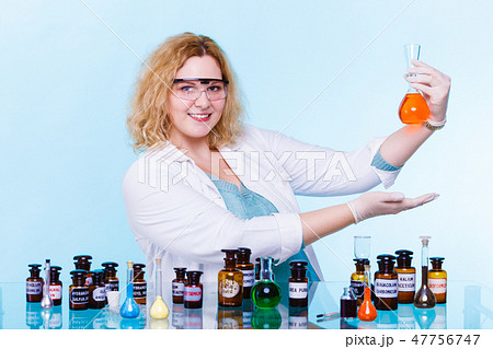 female chemistry student with glassware test flask. female chemistry student with glassware test flask. 47756747