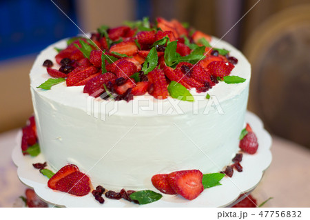 a wedding cake with cream and strawberries 47756832