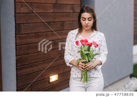 Happy woman hold a bouquet of flowers. 8th of march Happy woman hold a bouquet of flowers. 8th of march 47758630