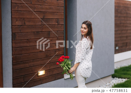 Happy woman hold a bouquet of flowers. 8th of march Happy woman hold a bouquet of flowers. 8th of march 47758631