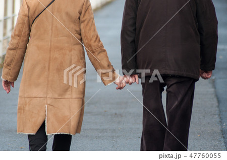 senior couple walking in the street senior couple walking in the street 47760055