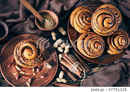 Cinnamon rolls buns with peanuts on a plate Cinnamon rolls buns with peanuts on a plate 47761226