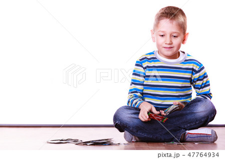 Little boys have fun and play cards. 47764934