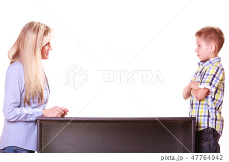 Mother and son talk and argue sit at table. Mother and son talk and argue sit at table. 47764942