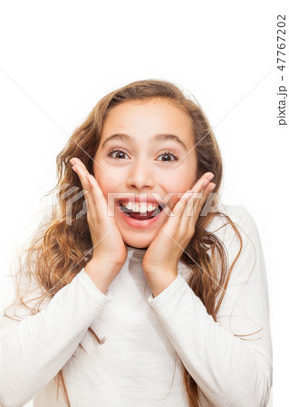 Smiling young girl looking happily surprised Smiling young girl looking happily surprised 47767202