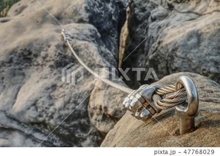 Stainless cable fixed to the rock for the safety Stainless cable fixed to the rock for the safety 47768029