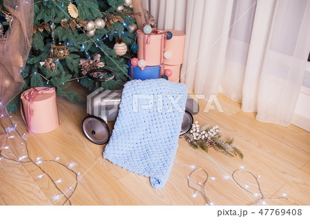 Very gentle and beautiful blankets lie near the New Year tree. Photo session in the photo studio 47769408