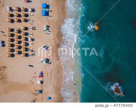 Beach with sun loungers on the coast of the ocean Beach with sun loungers on the coast of the ocean 47770450