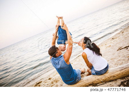 Theme family weekend, beach summer vacation with child. Young stylish family of three dad mom and Theme family weekend, beach summer vacation with child. Young stylish family of three dad mom and 47771746