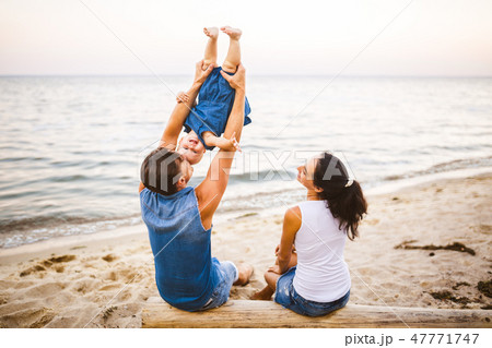 Theme family weekend, beach summer vacation with child. Young stylish family of three dad mom and 47771747
