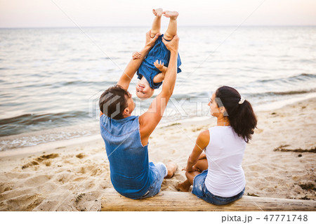 Theme family weekend, beach summer vacation with child. Young stylish family of three dad mom and 47771748