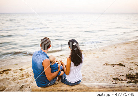 Theme family weekend, beach summer vacation with child. Young stylish family of three dad mom and 47771749