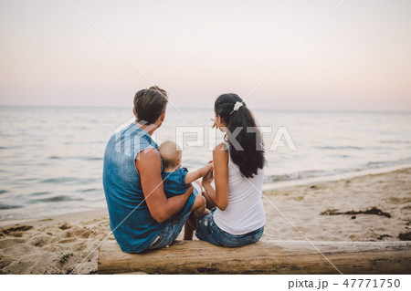 Theme family weekend, beach summer vacation with child. Young stylish family of three dad mom and 47771750
