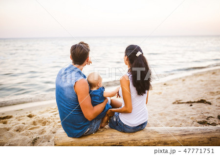 Theme family weekend, beach summer vacation with child. Young stylish family of three dad mom and 47771751