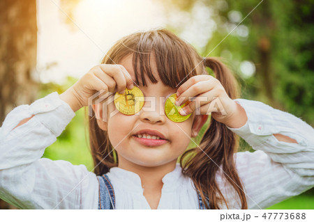 Little girl kid holding bitcoin digital money. 47773688
