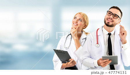 Doctor at hospital works on computer with partner. 47774131