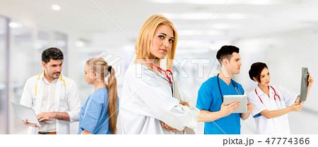 Doctor working in hospital with other doctors. Doctor working in hospital with other doctors. 47774366