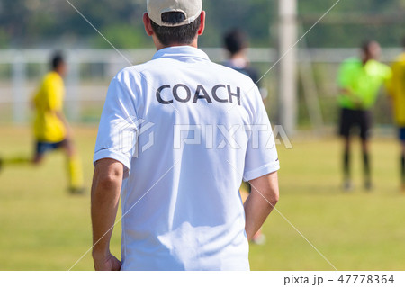 Back of football coach wearing white COACH shirt Back of football coach wearing white COACH shirt 47778364