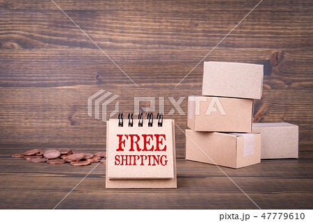 Free shipping concept. Paper boxes on wooden background Free shipping concept. Paper boxes on wooden background 47779610
