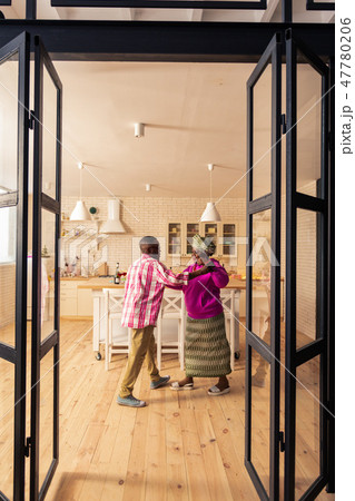 Happy delighted couple dancing in the kitchen 47780206