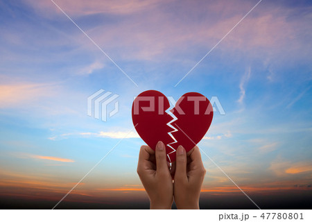 Woman hand holding broken paper red heart Woman hand holding broken paper red heart 47780801