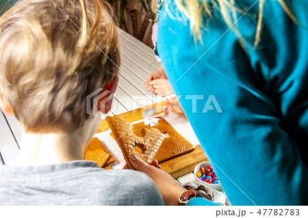 Familiy building a sweet ginger bread house Familiy building a sweet ginger bread house 47782783