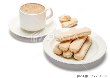 White ceramic cup of coffee with a savoiardi ladyfinger cookie on a plate 47784080