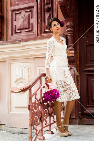 Young beautiful woman with flowers 47788276